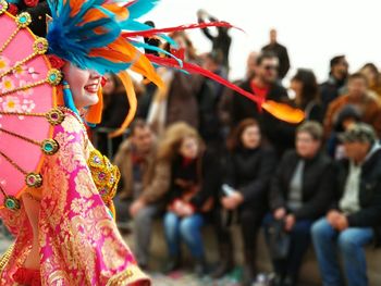Side view of smiling dancer in costume performing at street