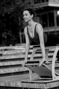 Portrait of young woman exercising in gym