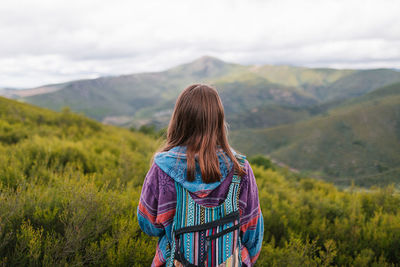 Rear view of woman looking at mountains