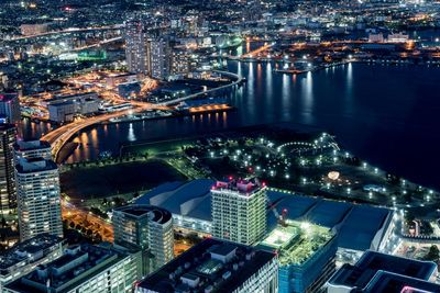 High angle view of city lit up at night