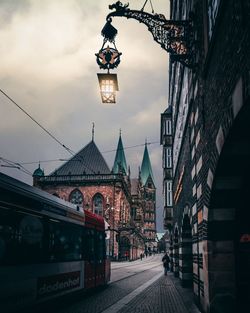 Street amidst buildings in city against sky