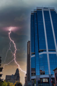 Low angle view of buildings against sky at sunset