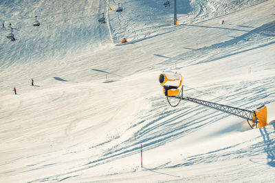 Aerial view of people skiing on snowcapped mountain