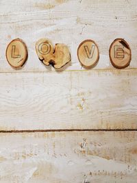 High angle view of love text on wooden table