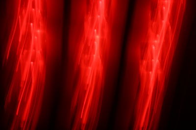 Full frame shot of illuminated red light against black background