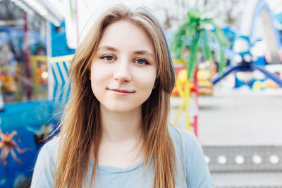 Happy young gen z woman in amusement park, smiling