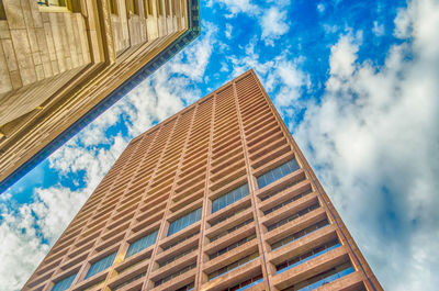 Low angle view of building against cloudy sky