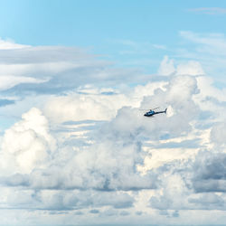 Low angle view of helicopter  flying in sky