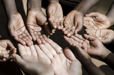 Cropped image of people showing hands