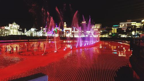 Illuminated buildings in city at night