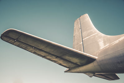 Low angle view of airplane flying against sky