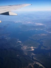 Cropped image of airplane flying over landscape