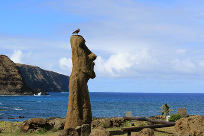 Rock formations by sea against sky