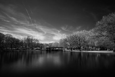 Scenic view of calm lake against cloudy sky