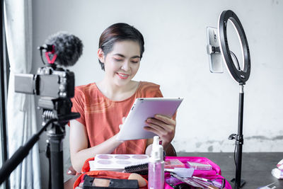 Woman photographing with mobile phone