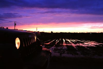 Silhouette of landscape against cloudy sky at sunset