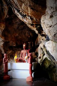 Woman standing on rock in cave