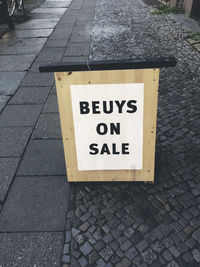 High angle view of information sign on sidewalk