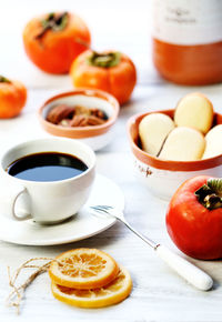 Close-up of orange and coffee on table