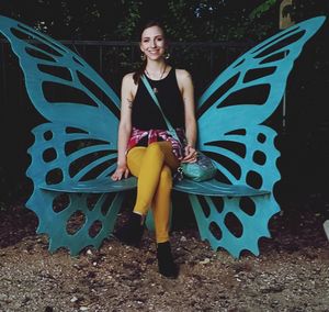 Portrait of smiling young woman standing outdoors