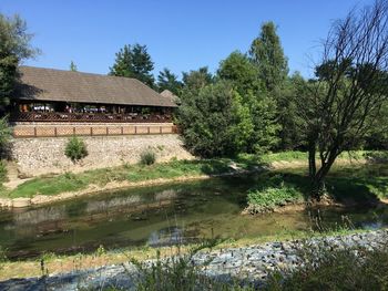 Scenic view of lake by building against clear sky