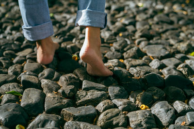 Low section of man standing on rock