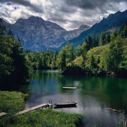 Scenic view of lake and mountains against sky