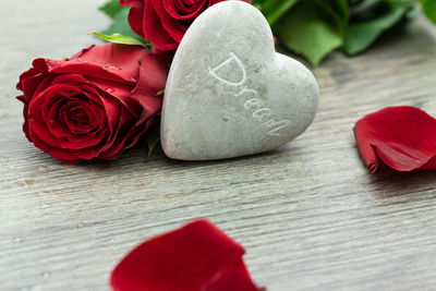 Close-up of red rose on table