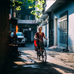 Mature woman riding bicycle on street