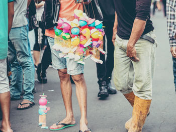 Low section of people walking on street