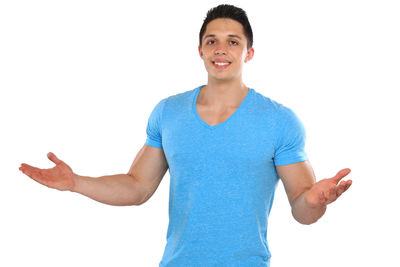 Portrait of young man standing against white background