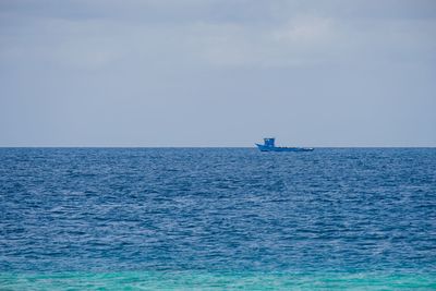 Sailboat sailing in sea against sky