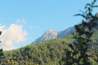 Scenic view of mountains against blue sky