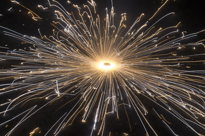 Low angle view of firework display at night