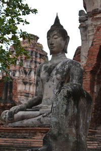 Low angle view of statue against historic building