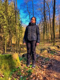 Portrait of man standing in forest