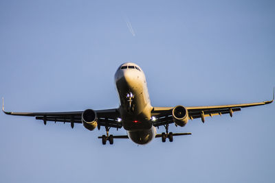 Low angle view of airplane against clear sky