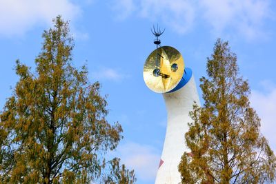 Low angle view of a bird on tree against sky