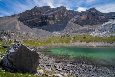 Scenic view of land and mountains against sky
