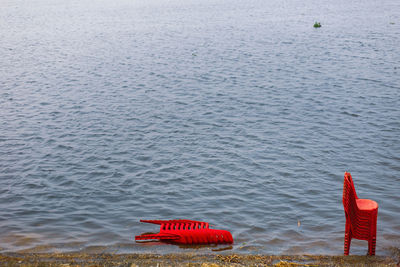 Red floating on sea shore summertime