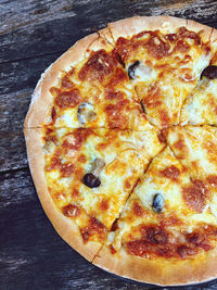 Close-up of pizza on wooden table