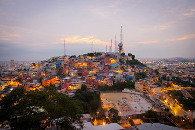 High angle view of illuminated cityscape against sky