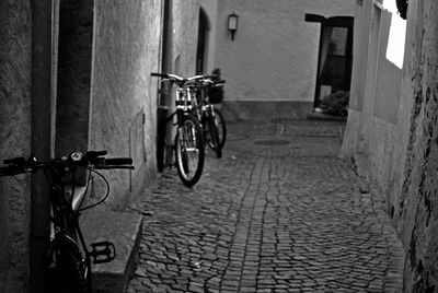 Bicycle parked against building