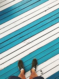 Low section of man standing on footpath