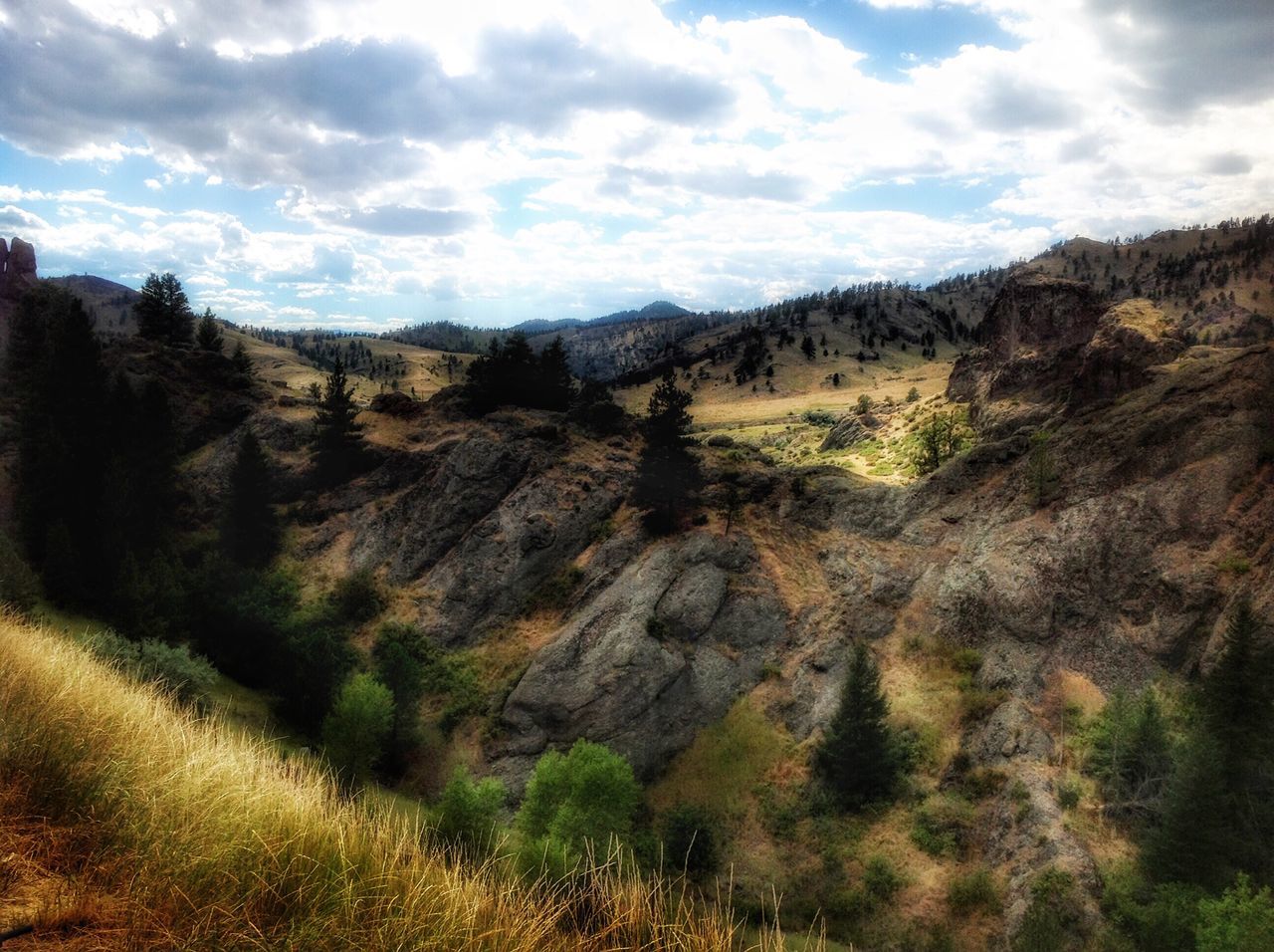 mountain, sky, tranquil scene, tranquility, scenics, landscape, cloud - sky, beauty in nature, nature, mountain range, cloud, non-urban scene, cloudy, tree, rock formation, physical geography, geology, remote, idyllic, rock - object