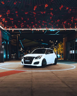 Cars parked in parking lot at night