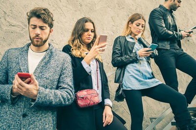 Friends standing on mobile phone