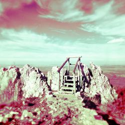 Abandoned built structure on beach against sky