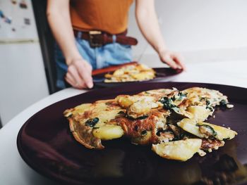 Midsection of man preparing food in plate