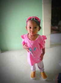 Portrait of cute girl with pink petals on floor